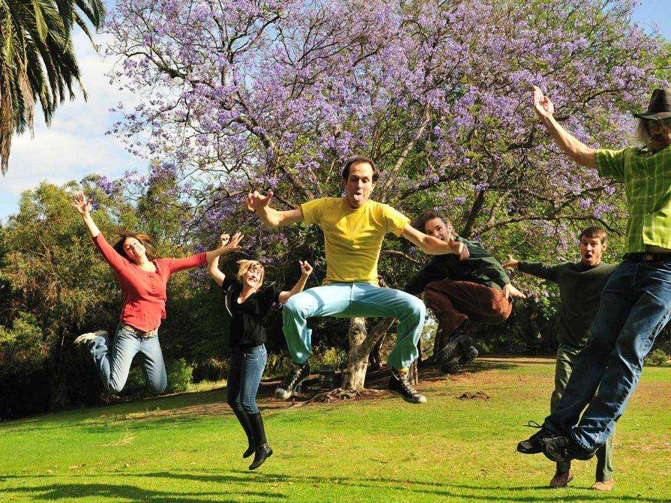 People jumping for joy in a park