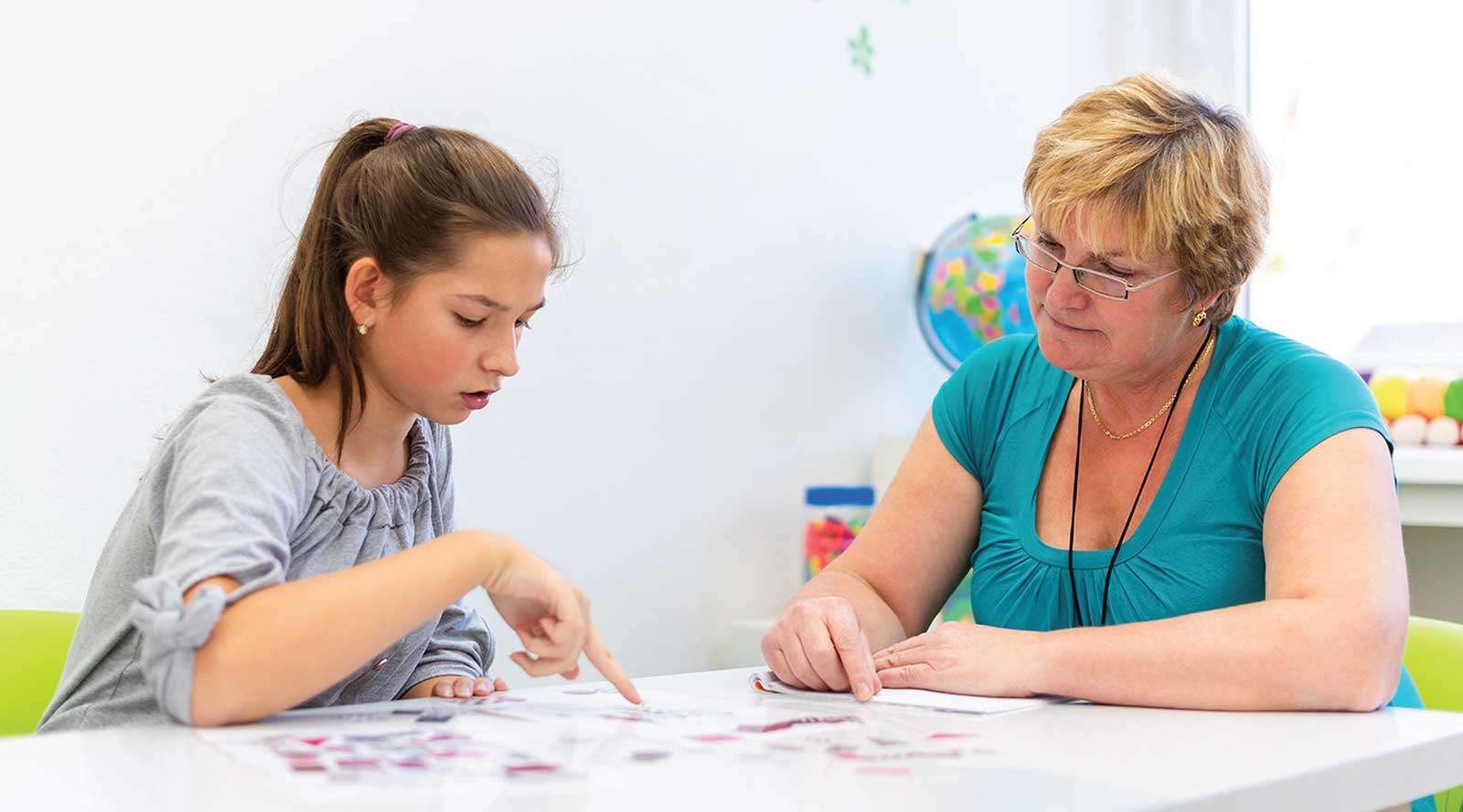 A girl being taken through assessments by a female assessor