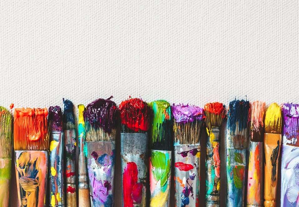 Row Of Artist Paintbrushes Closeup On Artistic Canvas.