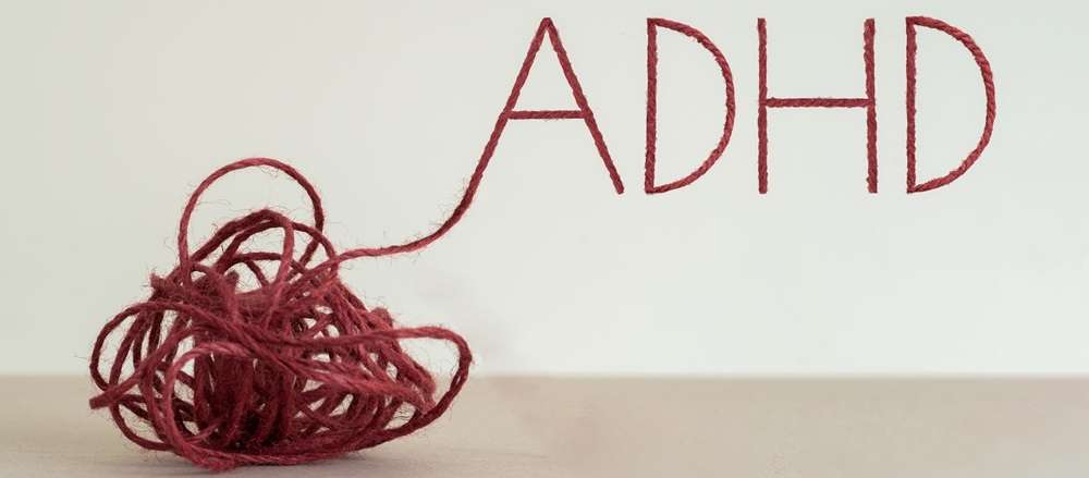 Knot of red rope writing the word ADHD