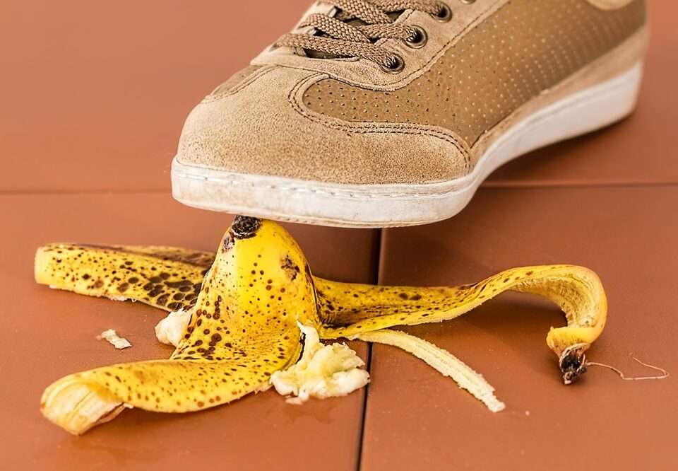 A shoe about to step and slip on a banana peel