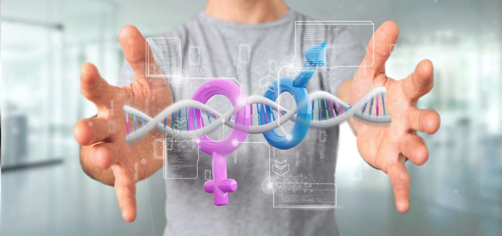 A man holding a chain of DNA with the female and male symbols