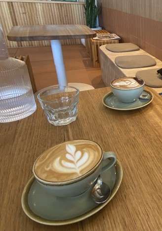 Cups of coffee on a wooden table