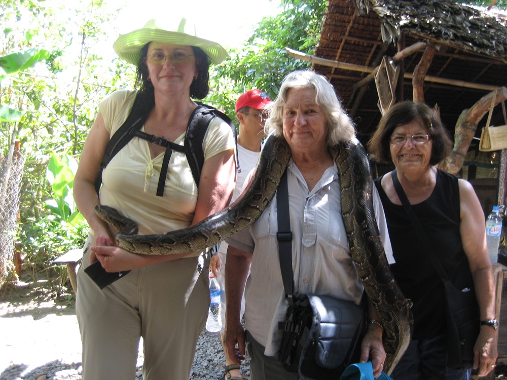 Maria with her mother holding a snake in Vietnam