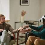 A male therapist treating a female patient using VR glasses to overcome her phobia