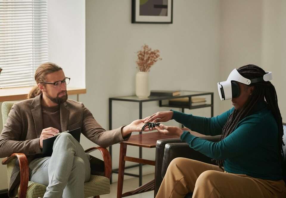 A male therapist treating a female patient using VR glasses to overcome her phobia