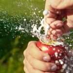 A man's hands opening a can of soft drink and it fizzes out