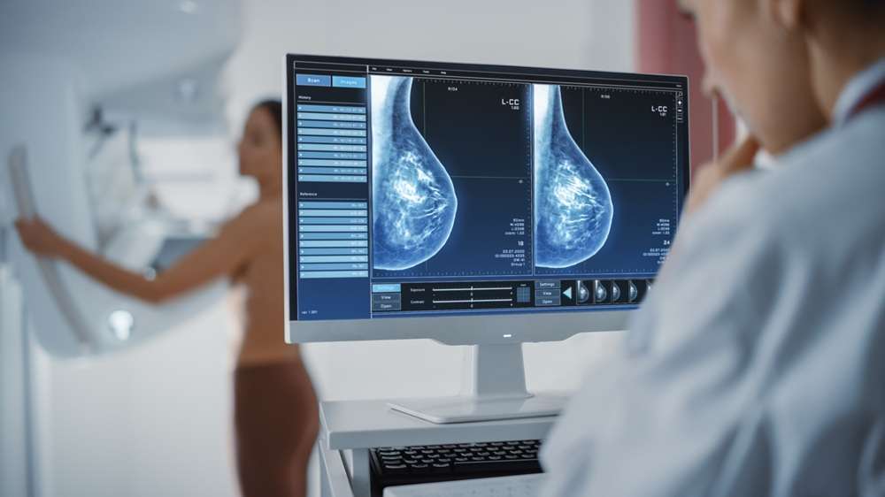 Breast Scan - Paragon PsychConnect A technician reviewing a breast scan image on a computer screen