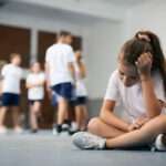 Female student sitting away from her classmates