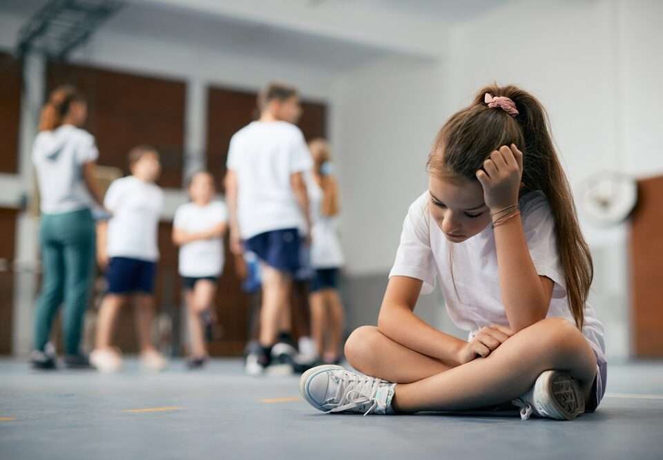 Female student sitting away from her classmates