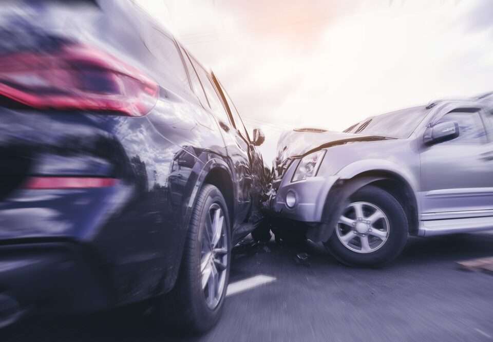 Two cars have crashed together at an angle