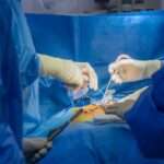 Back Surgery - Paragon PsychConnect Two surgeons operating on a patients back