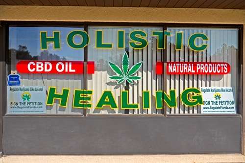 A medical cannabis oil shop front with Holistic Healing on the window