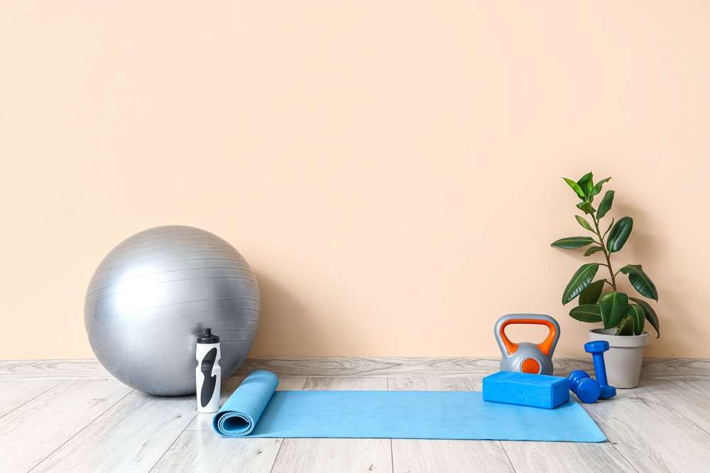 Exercises at Home - Paragon PsychConnect Sports equipment with water bottle and plant near beige wall