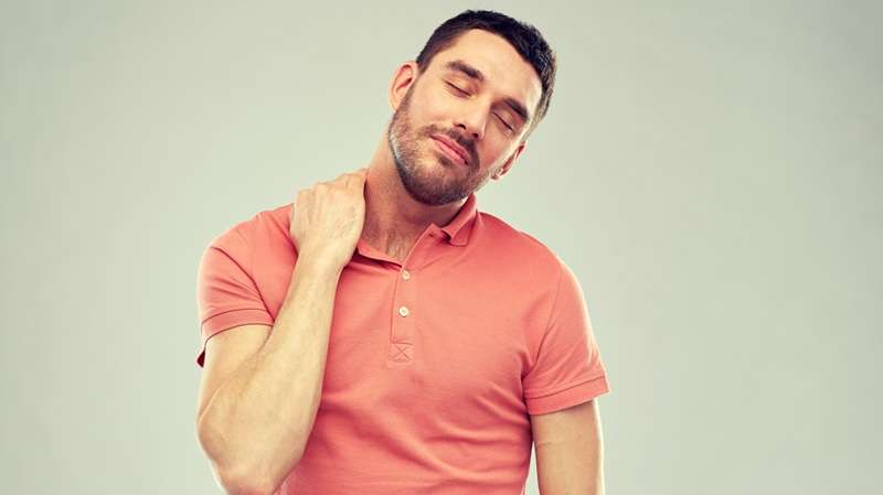 Person experiencing neck pain and cautiously limiting movement