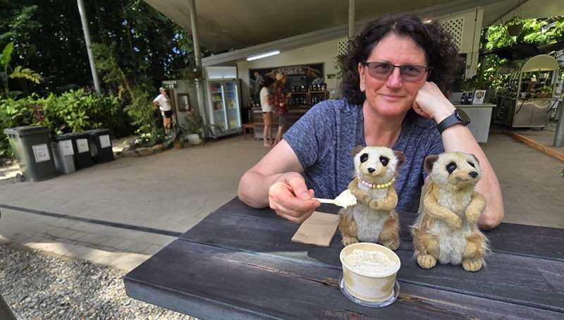 Life Beyond Symptoms – Recovery and Enjoyment - Paragon PsychConnect Maria sitting at an outdoor table feeding ice cream to our meerkats Arnie and Essie