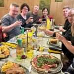 Friends sharing dinner and conversation, illustrating the importance of social connection and mental wellbeing