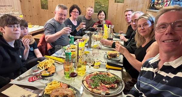Friends sharing dinner and conversation, illustrating the importance of social connection and mental wellbeing